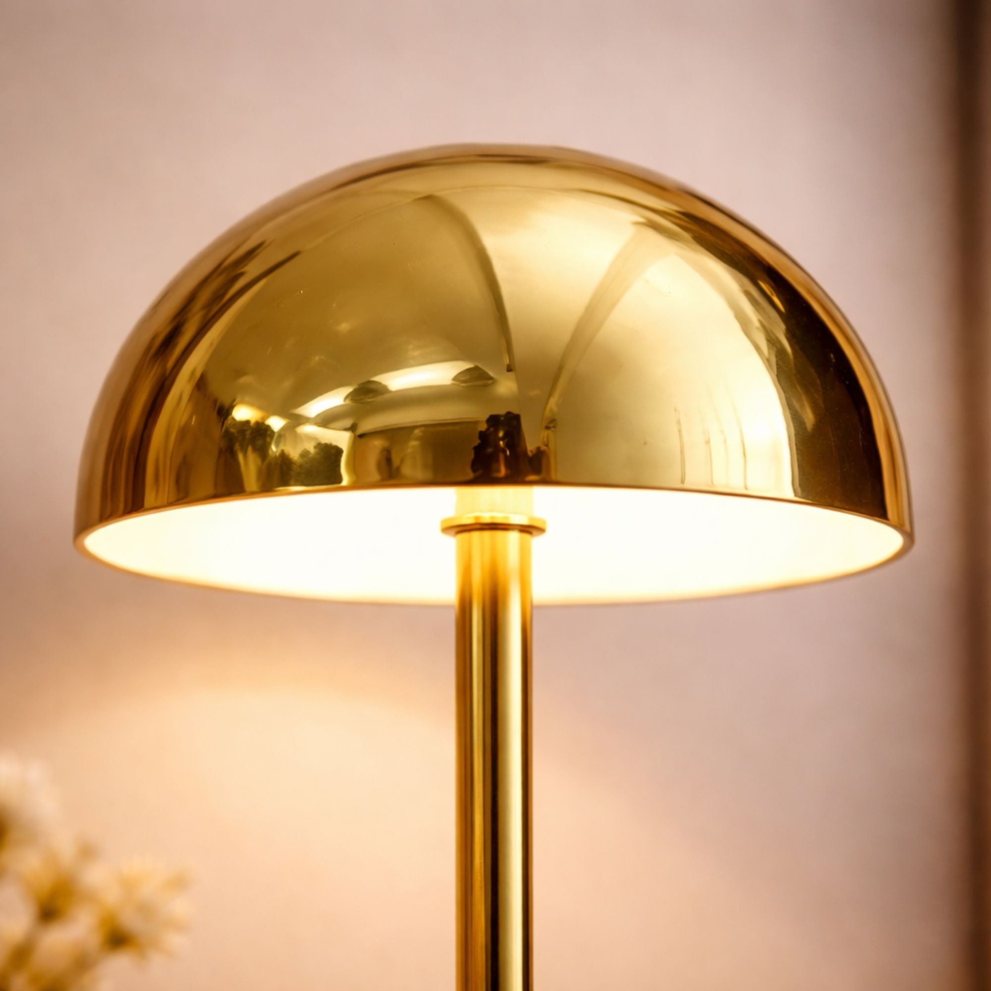 Detaljbild av guld bordslampa i svampdesign med LED ljus och stilren metallfinish