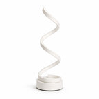 Modern LED-bordslampa i svart med slingrande design och varm belysning.