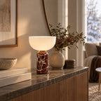 Bordslampa KINZO i rödbrun marmor på konsolbord med naturinredning.