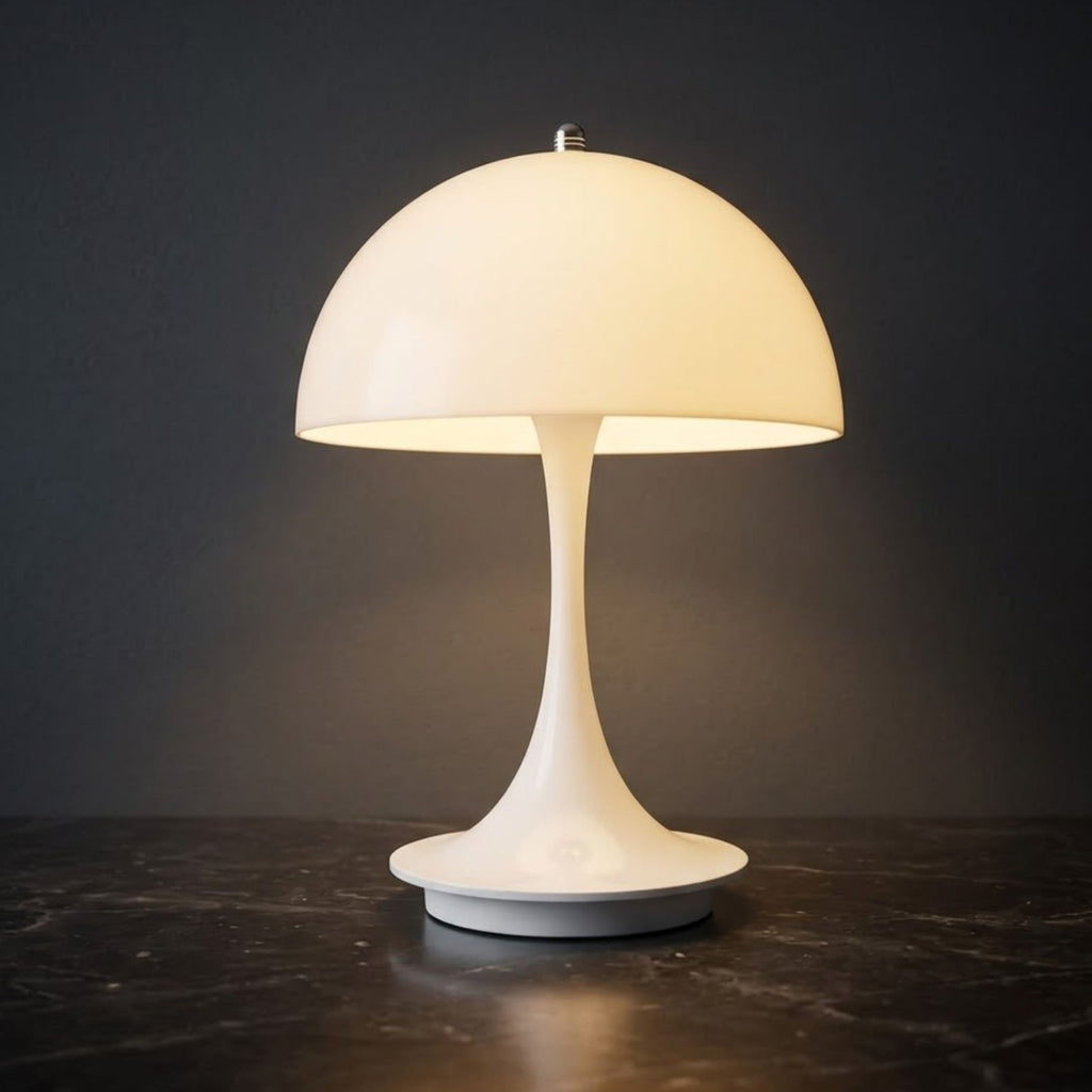 Portabel vit LED bordslampa i svampdesign som lyser med varm belysning mot mörk bakgrund