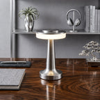 Bordslampa i silver med uppladdningsbar LED placerad på skrivbord i modern inredning, ger stilren och behaglig belysning