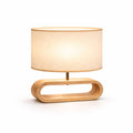 bordslampa i trä med oval bas och tygskärm i modern design på vit bakgrund