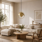 Modern guld färgad taklampa i ljust skandinaviskt vardagsrum med stilren inredning.