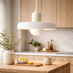 taklampa i modern vit design placerad i skandinaviskt kök som ger ett mjukt och stilrent ljus över köksbänk